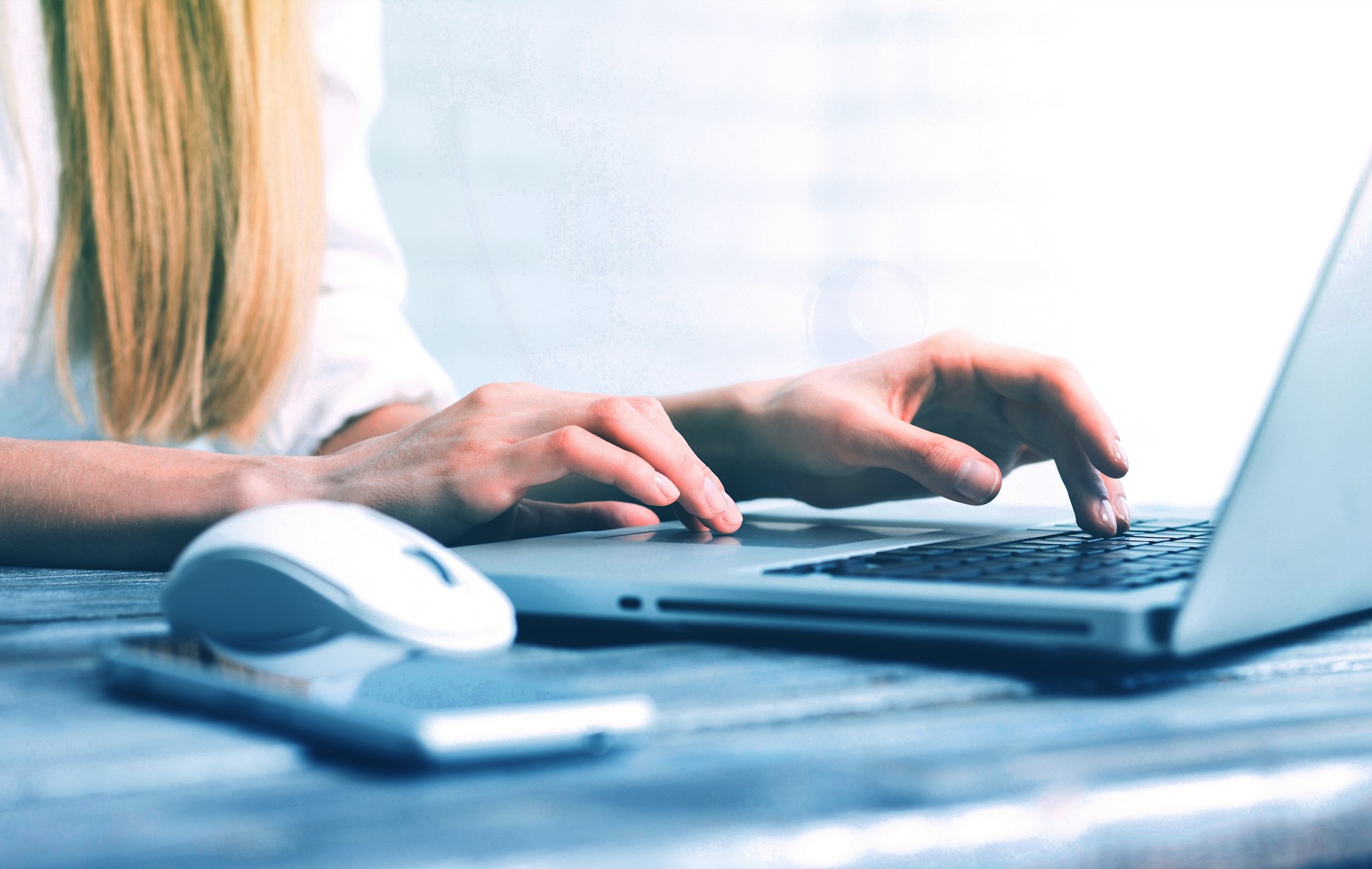 close-up of woman working on computer to generate real estate leads - Ollin Reach